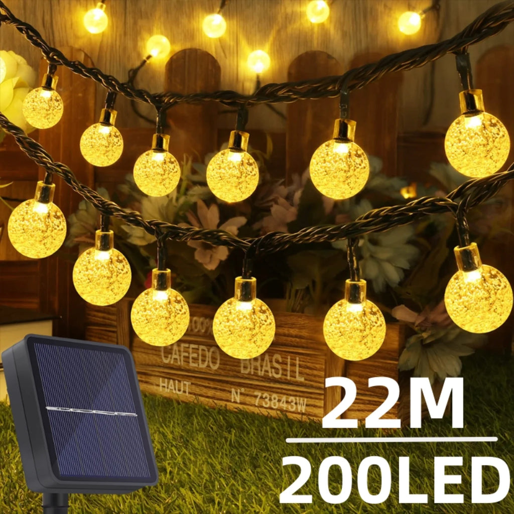 Solar Crystal Globe String Lights with faceted LED bulbs in a garden